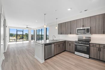 A modern kitchen with wooden cabinets and stainless steel appliances.